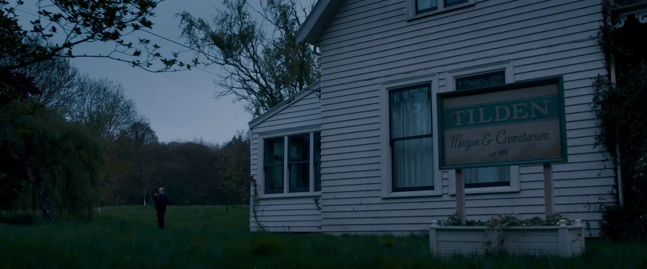 The Autopsy of Jane Doe (2016) movie still: wide — A rural property features a white clapboard building with a Tilden Morgue sign. A solitary older…
