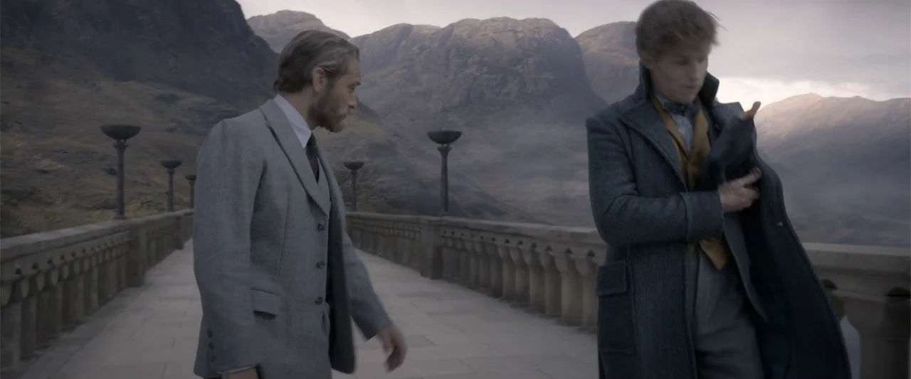 Fantastic Beasts: The Crimes of Grindelwald (2018) movie still: medium — A long stone bridge spans across a vast valley with high mountains in…