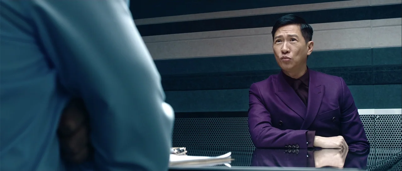 Line Walker (2016) movie still: medium — An interrogation room features horizontal sound-dampening wall panels and a reflective metal table. A man…