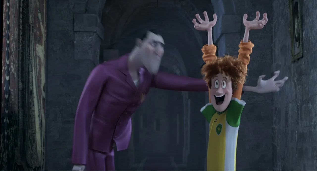 Hotel Transylvania 2 (2015) movie still: medium — A stone corridor features high arched ceilings and a dark tapestry hanging on the left. A tall man…
