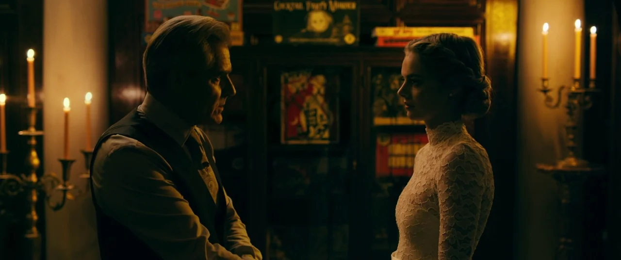 Ready or Not (2019) movie still: medium — A dimly lit room features dark wood shelving filled with game boxes and candles. A man in a vest and a…