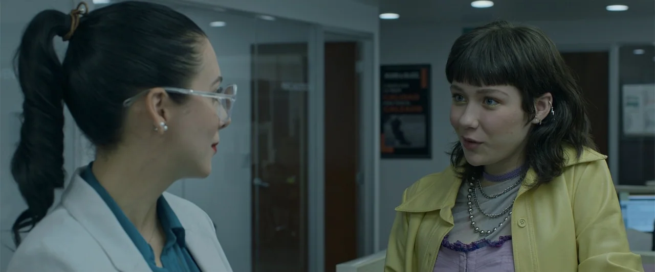Mirreyes contra Godínez 2: El retiro (2022) movie still: medium — An office interior with glass partitions and visible professional signage in the…