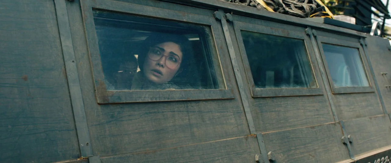 Jurassic World: Fallen Kingdom (2018) movie still: medium — A dark green steel armored vehicle features rectangular windows set into thick plate…