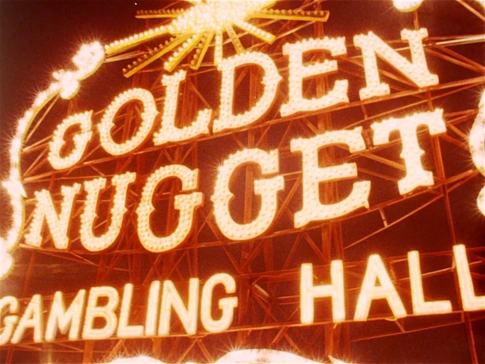 One From The Heart (1982) movie still: closeup — A close-up view of the illuminated Golden Nugget gambling hall sign at night. The structure is…