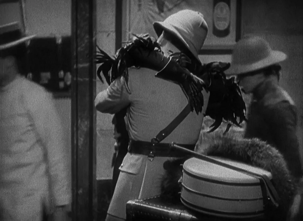 Shanghai Express (1932) movie still: medium — An interior space features people in vintage headwear standing near luggage and boxes. A central…