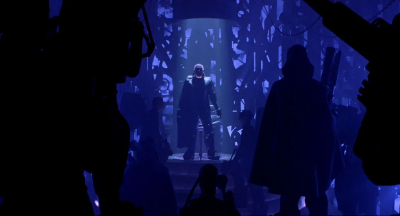 Bill and Ted’s Bogus Journey (1991) movie still: fullbody — A dark space defined by deep blue light features a central circular elevated dais. A…