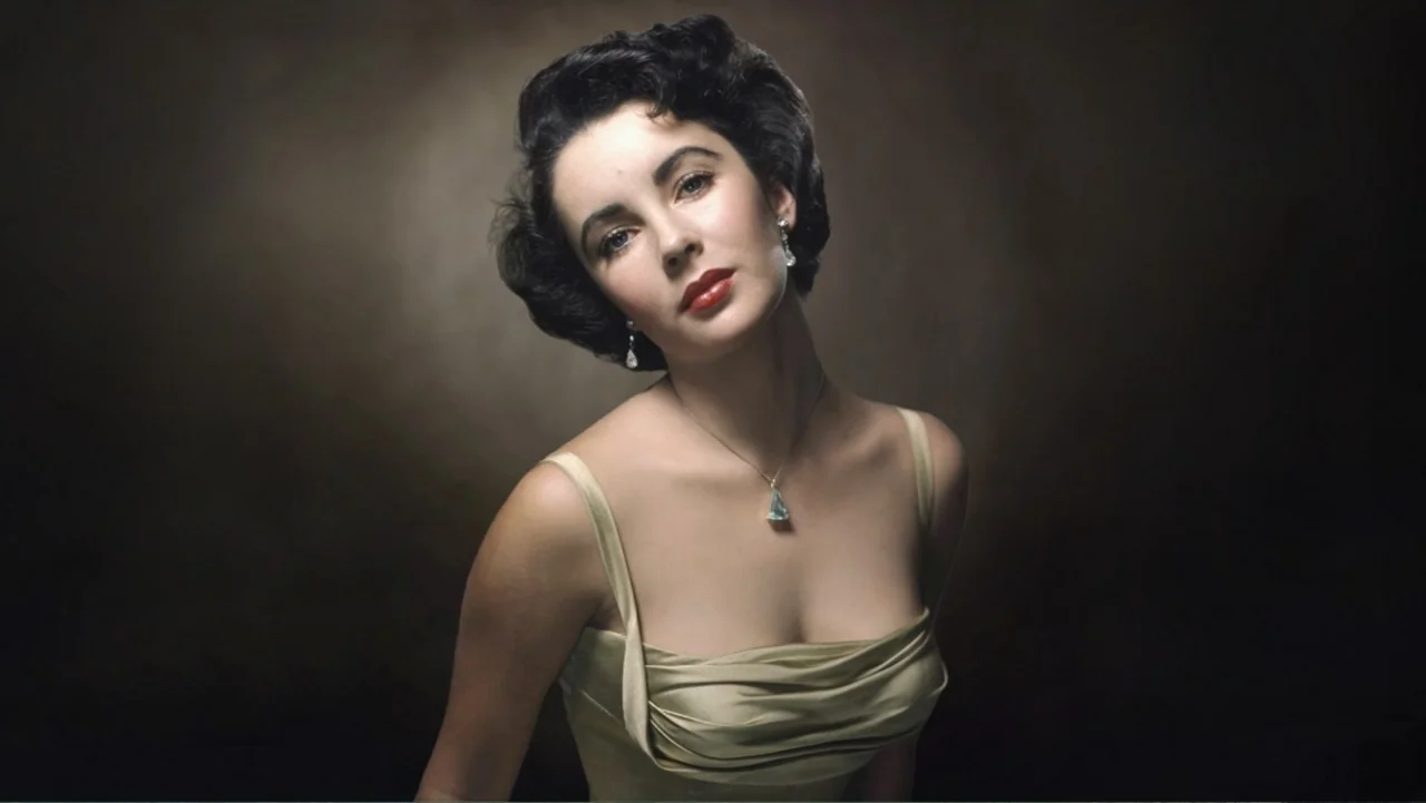 Elizabeth Taylor: The Lost Tapes (2024) movie still: medium — A studio portrait against a simple dark textured backdrop. A young woman poses for a…
