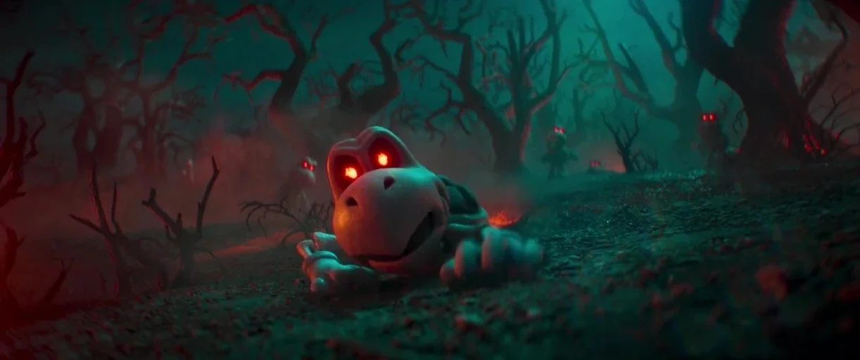 The Super Mario Bros. Movie (2023) movie still: medium — A dark, misty forest landscape features jagged, leafless trees under a deep teal sky. A…