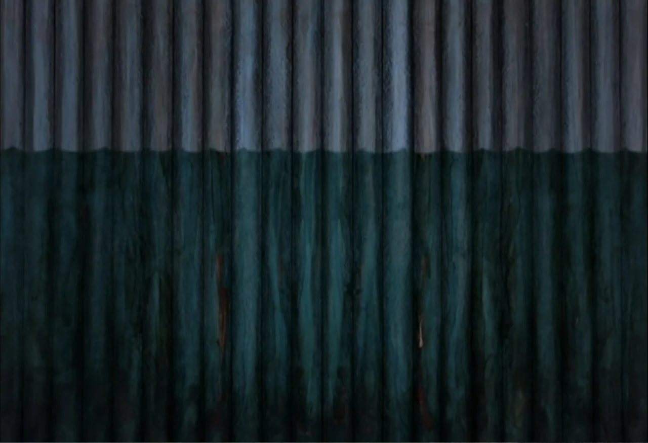 Indian Point: Imagining the Unimaginable (2004) movie still: establishing — A vertical corrugated metal wall divides the frame into two distinct…