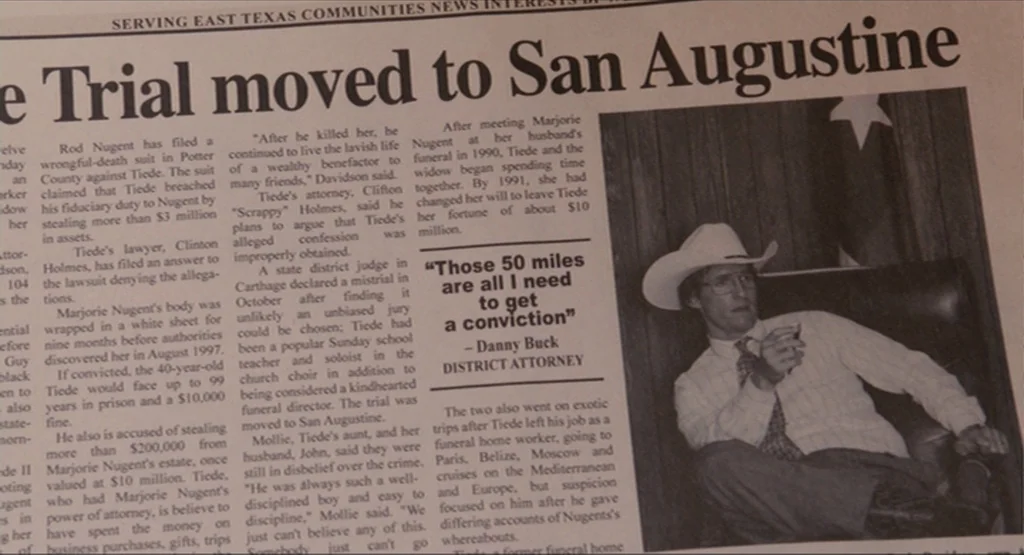 Bernie (2011) movie still: medium — A newspaper page features text columns and an embedded photograph of a man. The man sits in a leather chair…