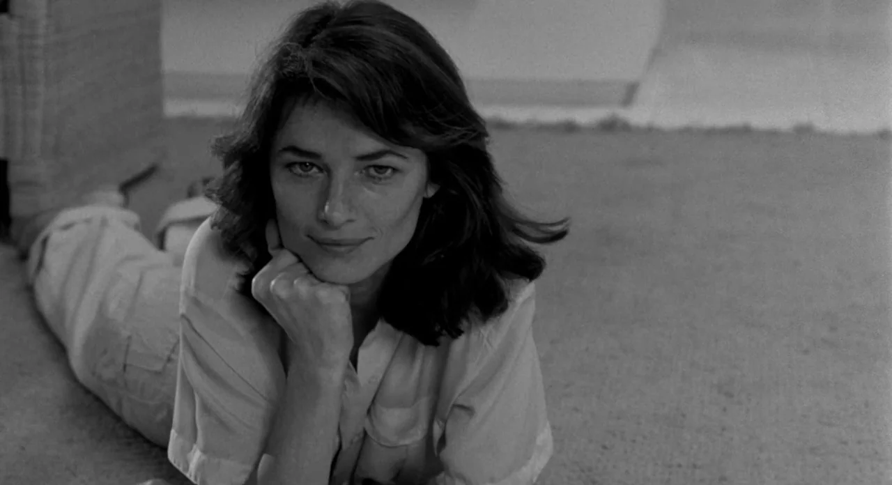 Stardust Memories (1980) movie still: medium — A woman lies on a carpeted floor in a brightly lit room. She rests her chin on her hand while facing…