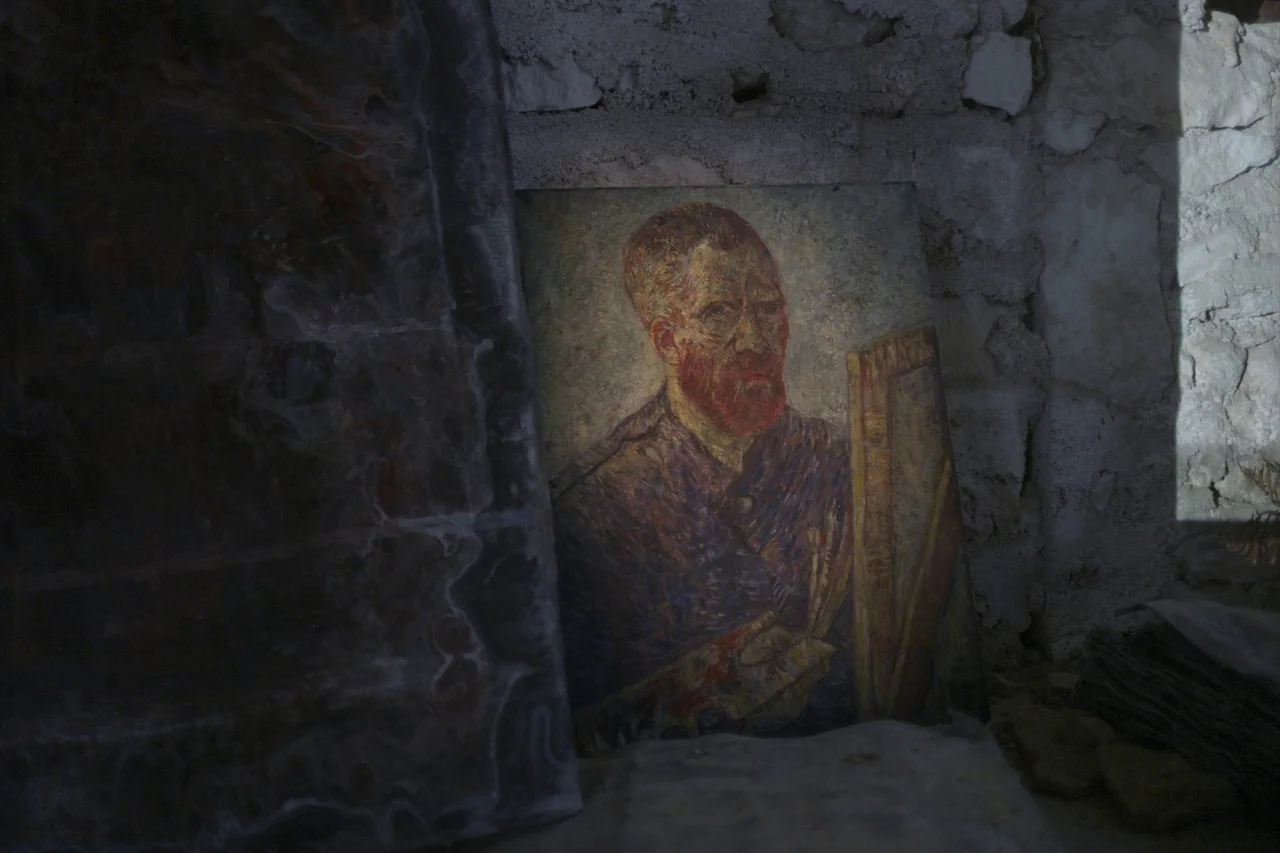 Anselm (2023) movie still: medium — A painting of Vincent van Gogh rests against a rough stone wall. Sunlight illuminates the portrait while the…