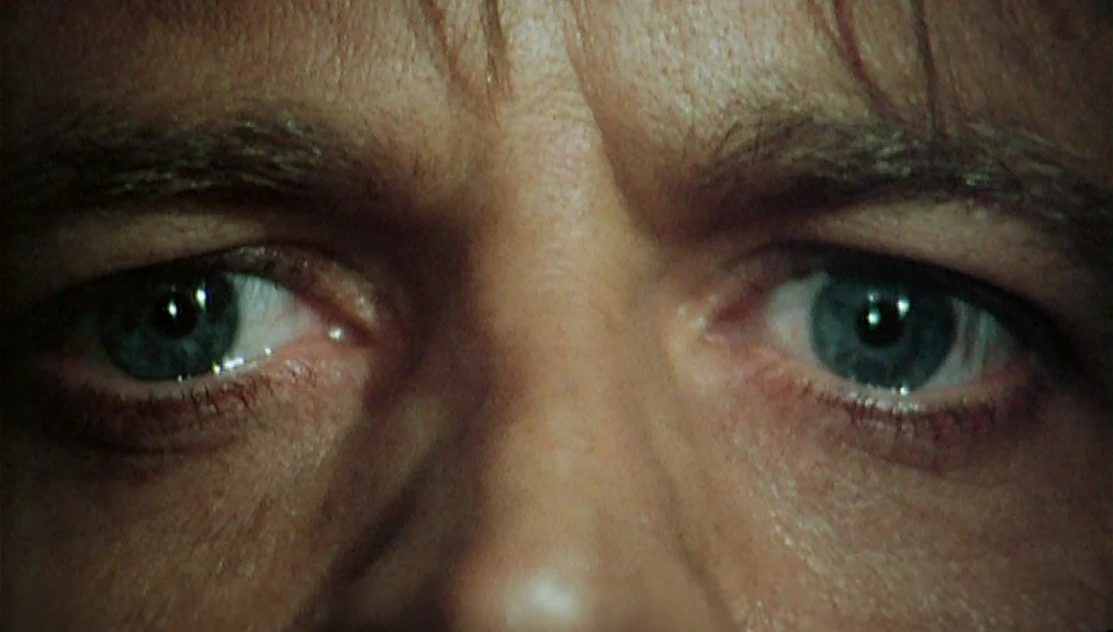 The Great Silence (1968) movie still: closeup — An extreme close-up focuses entirely on a pair of blue human eyes. The subject stares directly…