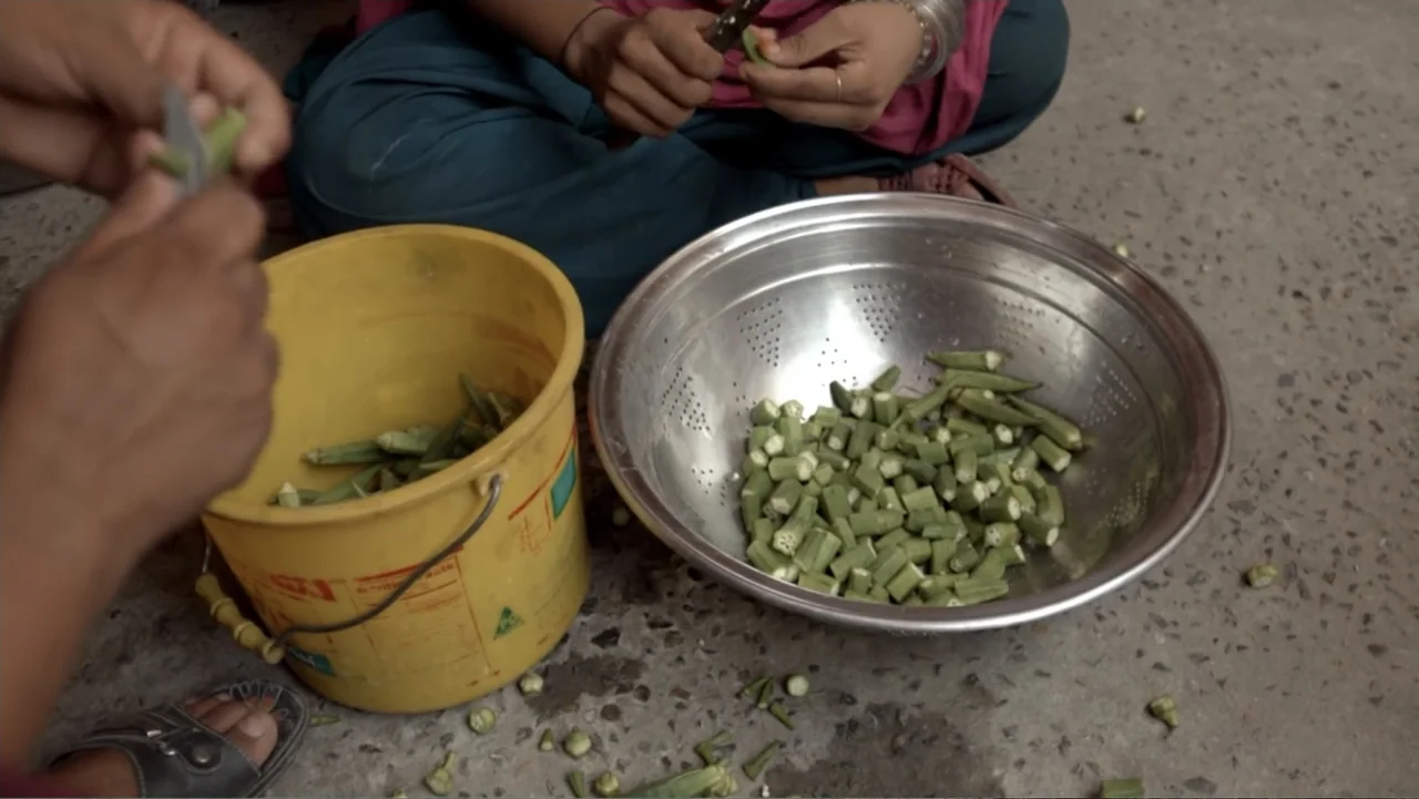 A Girl in the River: The Price of Forgiveness (2015) movie still: medium — A dusty outdoor ground surface holds a yellow plastic bucket and metal…