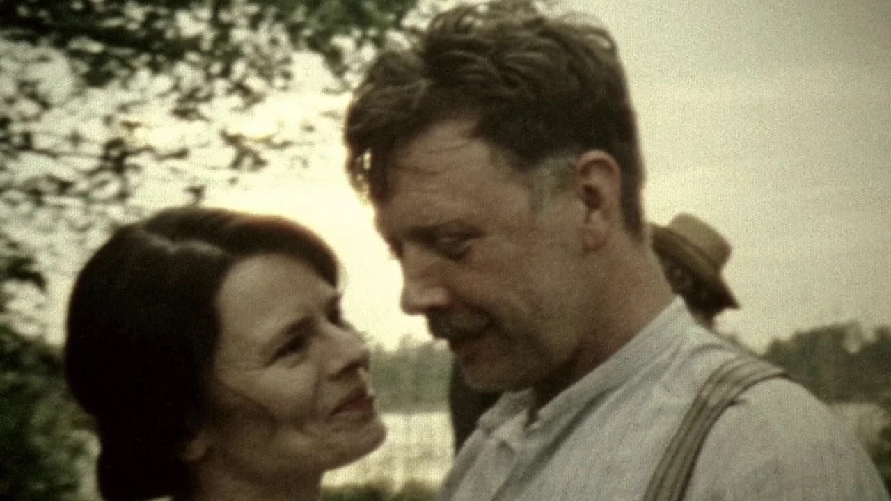 Everlasting Moments (2008) movie still: medium — An open field at sunset with blurred trees and a distant figure in background. A man in suspenders…