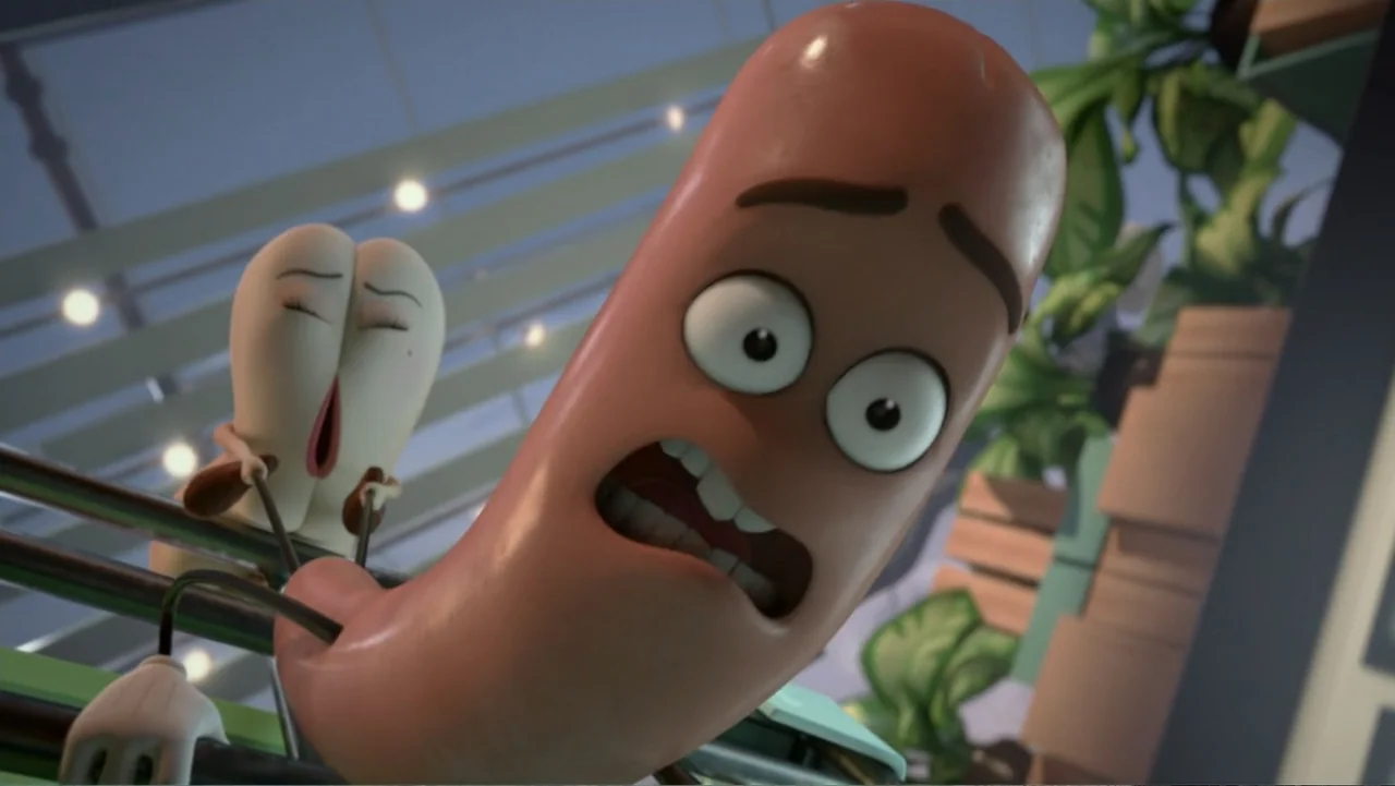 Sausage Party (2016) movie still: closeup — A grocery store interior with blurred aisles and shelving units in the background. A sausage character…