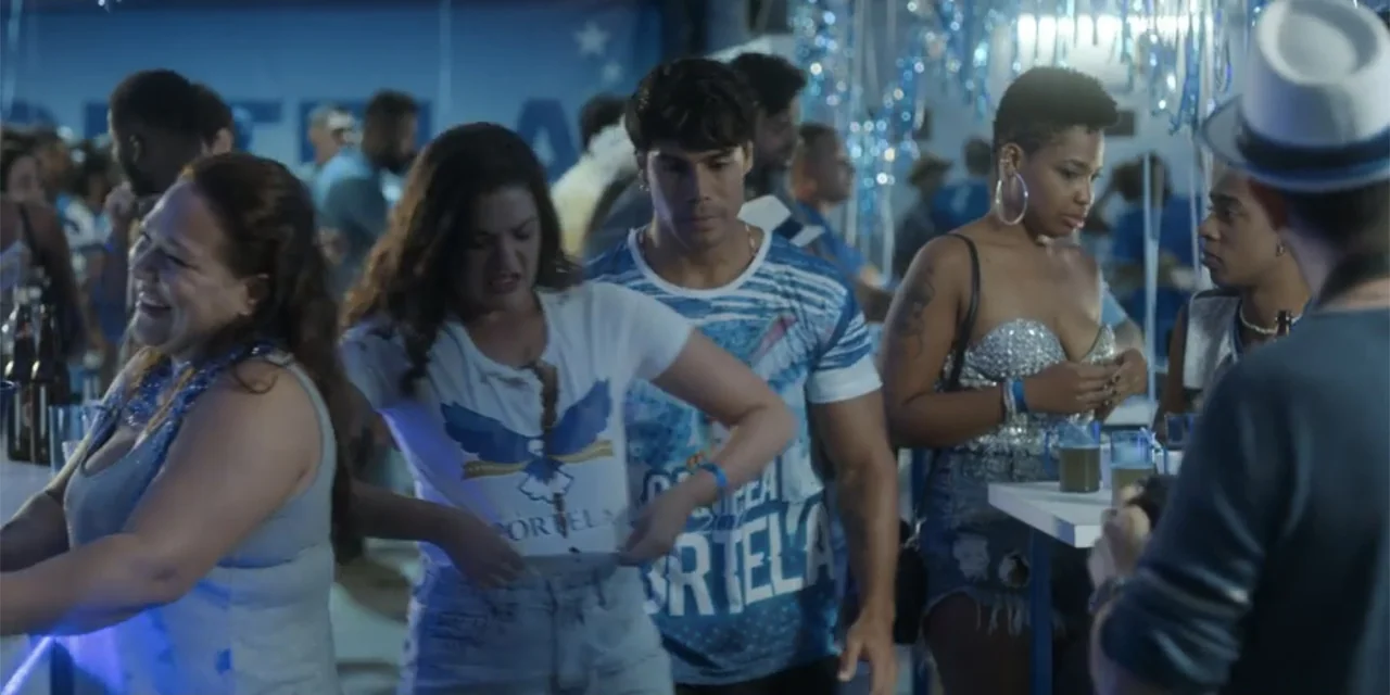 An Unforgettable Year - Summer (2023) movie still: medium — A social gathering with blue streamers and people standing around tables holding drinks.…