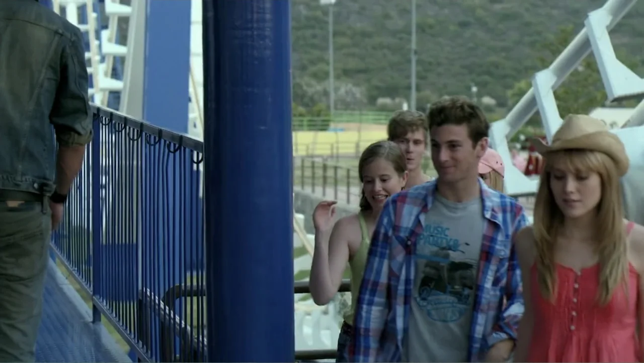 Loco Love (2003) movie still: medium — A metal viewing platform at an amusement park with white steel support beams. A small group of young adults…