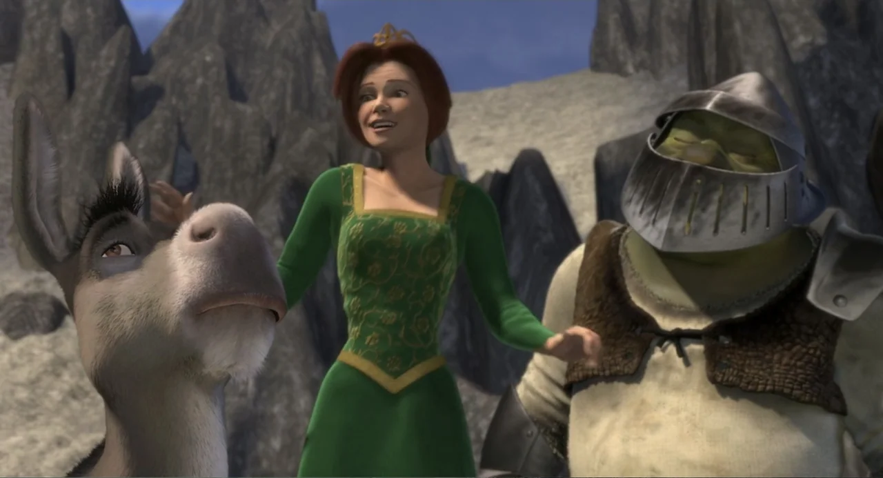 Shrek (2001) movie still: medium — A rocky mountain pass with jagged stone formations serves as the backdrop. A princess in a green dress stands…