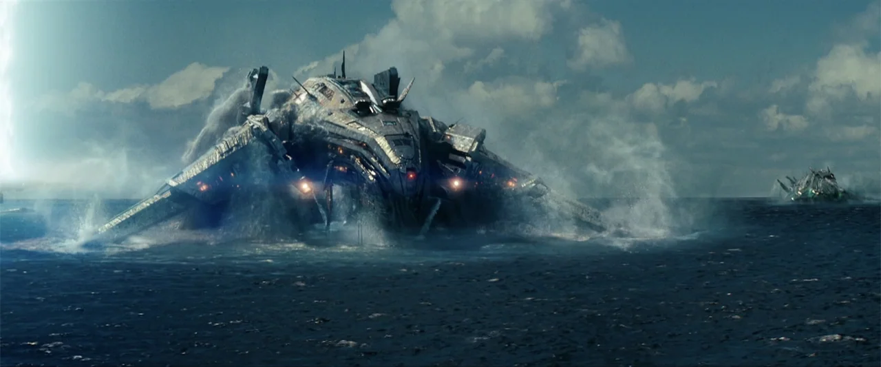 Battleship (2012) movie still: wide — A vast expanse of choppy blue sea with clouds against a bright sky. Two large, complex metallic alien ships…