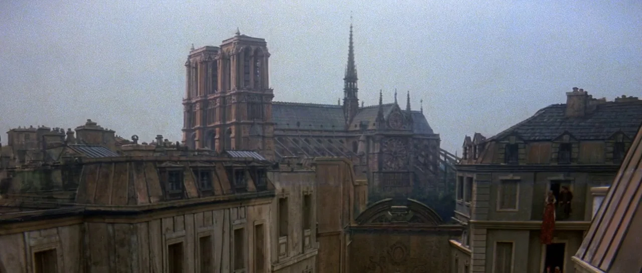 History of the World: Part 1 (1981) movie still: establishing — A dense urban environment featuring weathered stone buildings with dark mansard…