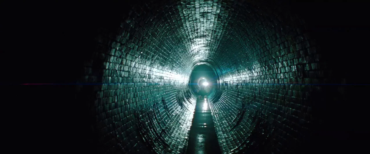 Mission: Impossible – Ghost Protocol (2011) movie still: wide — A dark, cylindrical tunnel constructed from dark, wet, curved brickwork stretches…