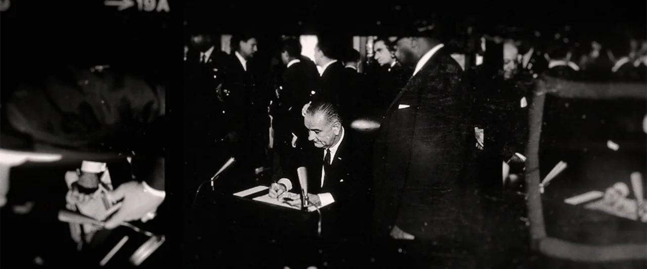 All In: The Fight for Democracy (2020) movie still: medium — A crowded government office interior with men in formal suits observing a formal event.…
