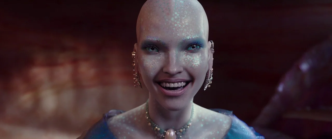 Valerian and the City of a Thousand Planets (2017) movie still: closeup — A dimly lit underwater space with muted warm-toned rocky surfaces visible…