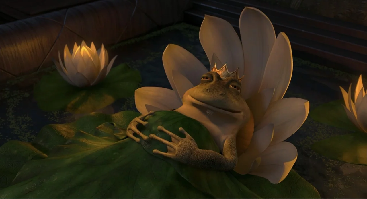 Shrek the Third (2007) movie still: medium — A dark, still pond features several large blooming white lilies on the surface. A frog wearing a small…