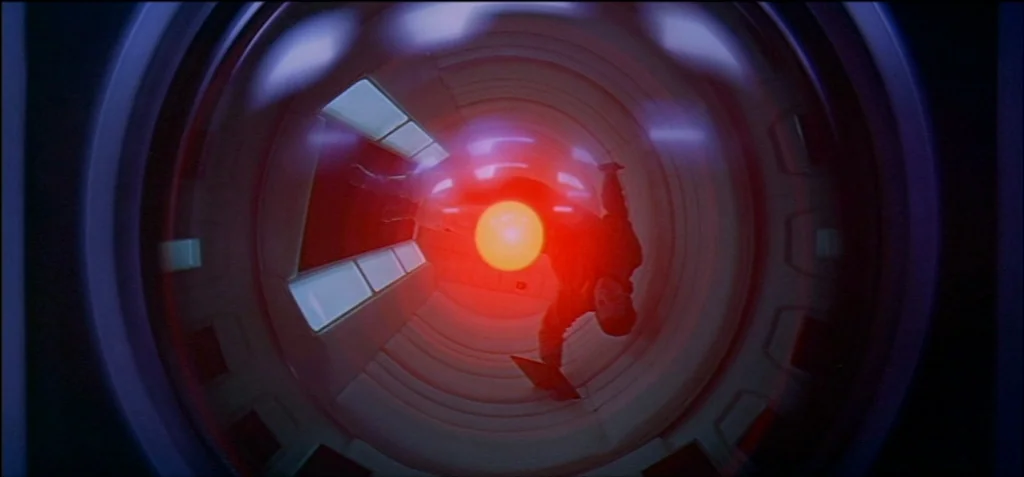 2001: A Space Odyssey (1968) movie still: wide — A circular, white-walled corridor features glowing geometric light panels and recessed…