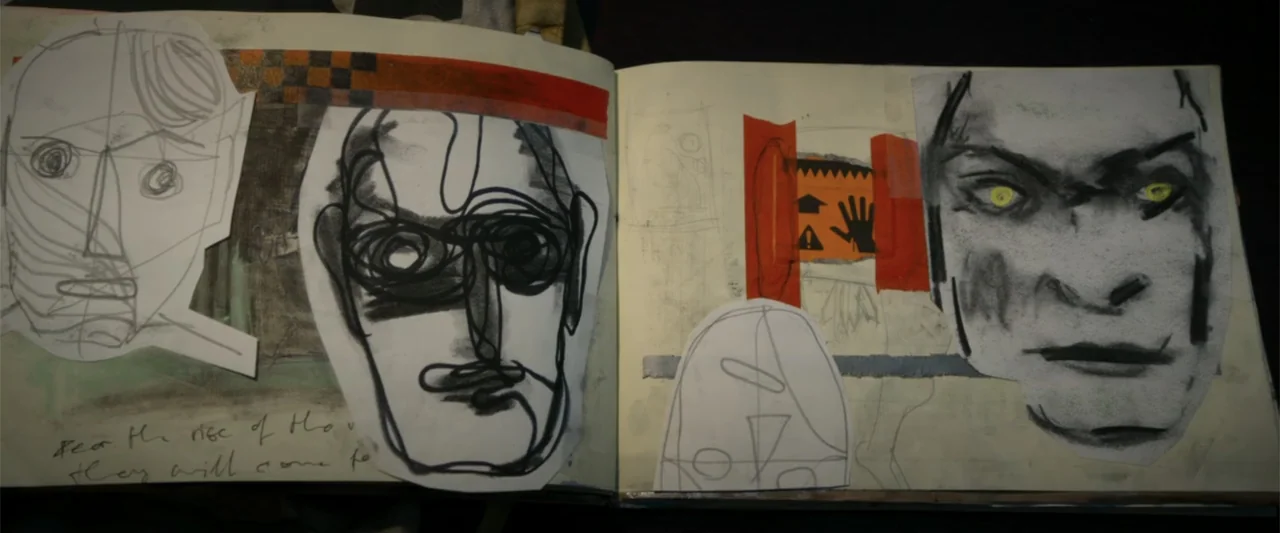 Heartburn (1986) movie still: medium — An open sketchbook features several abstract charcoal drawings and paper cutouts pasted onto the pages. The…