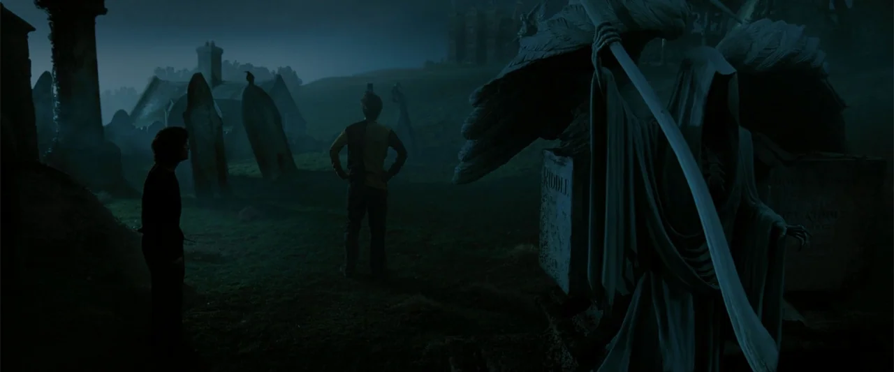 Harry Potter and the Goblet of Fire (2005) movie still: wide — A night graveyard contains numerous old tombstones and a large winged statue in…