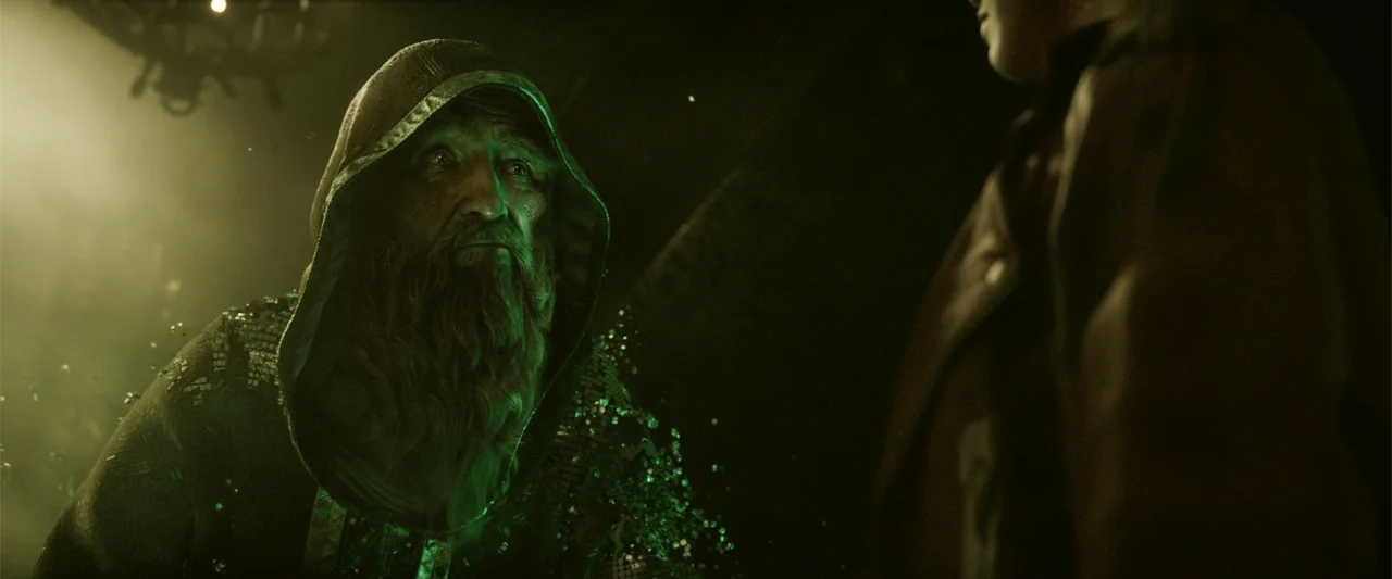 Ready Player One (2018) movie still: medium — A dark stone interior lit by a faint green glow with particulate matter floating. An elderly robed man…