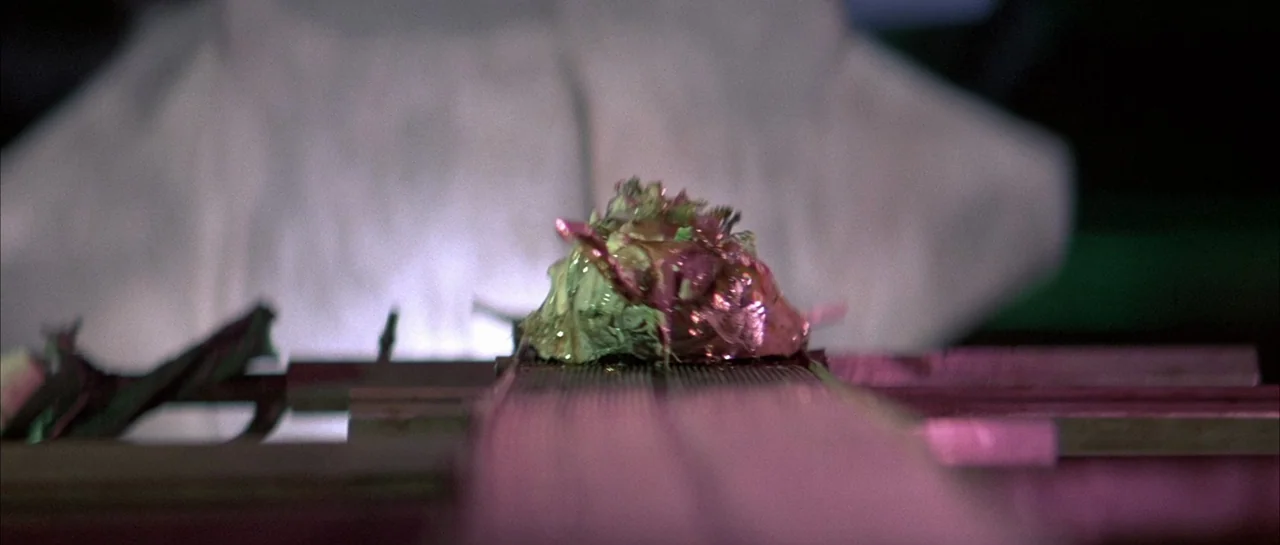 The Adventures of Buckaroo Banzai Across the 8th Dimension (1984) movie still: closeup — A scientific laboratory setting features a glowing, slimy…