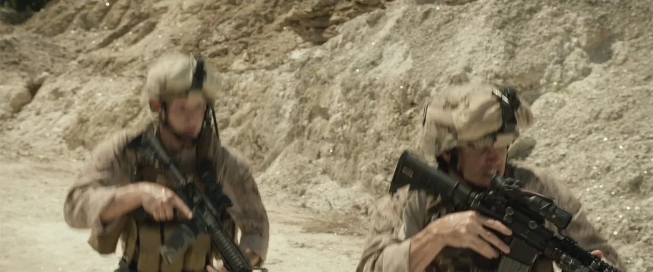 Max (2002) movie still: medium — A dry, sunlit limestone quarry features rough, light-colored rock formations in the background. Two soldiers in…