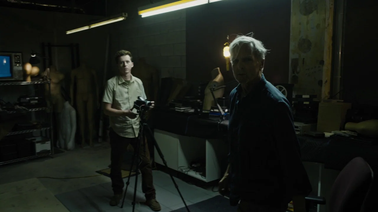 Fahrenheit 451 (2018) (2018) movie still: medium — A cluttered workshop contains multiple mannequins, camera gear, and electronic equipment in the…