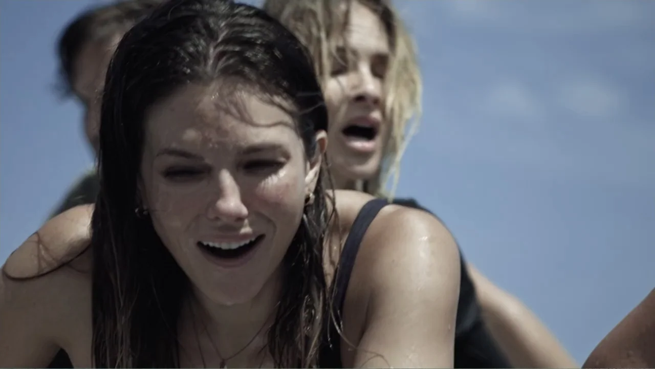 Capsized: Blood in the Water (2019) movie still: medium — Two women are positioned against a clear blue sky in an open water setting. Both figures…