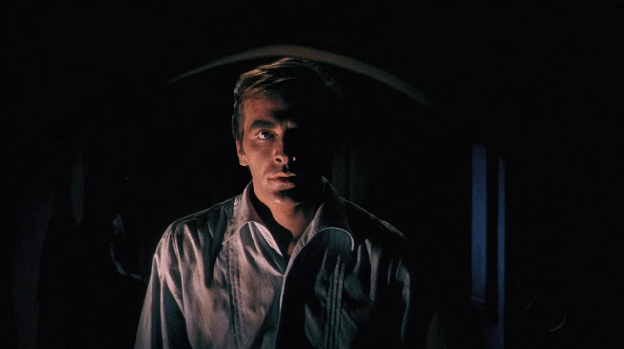 The Whip and The Body (1963) movie still: medium — A man in a white shirt stands in a dark architectural space with arches. The lighting highlights…