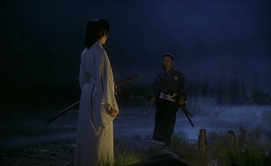 Gohatto (1999) movie still: fullbody — A misty, dark landscape near a river at night under dim moonlight. Two men in traditional samurai attire…