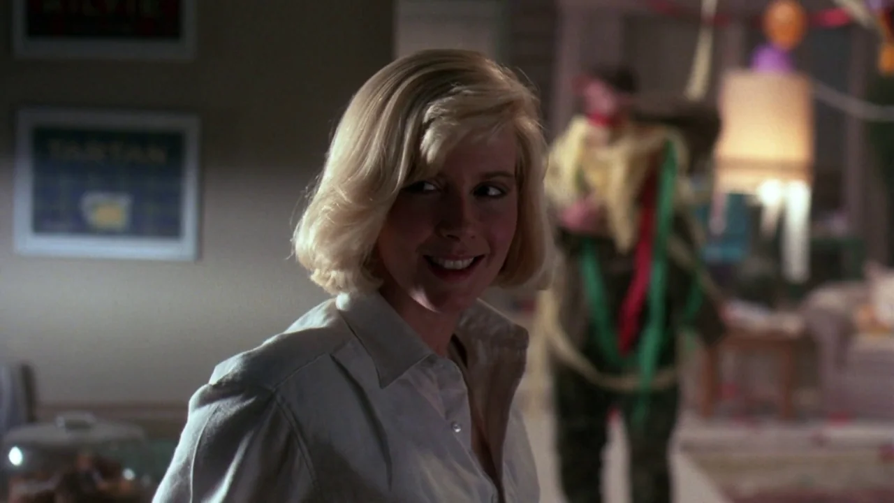 Friday the 13th Part VII: The New Blood (1988) movie still: medium — A domestic space contains a woman in the foreground and a blurred man behind…