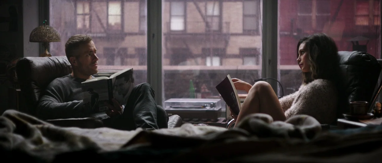 Deadpool (2016) movie still: medium — A furnished interior features two leather chairs positioned before a large window overlooking buildings. A man…