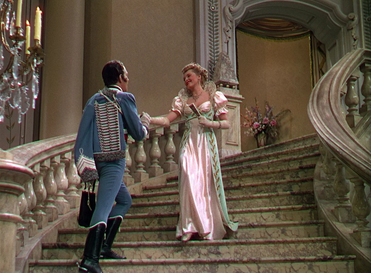 Phantom of the Opera (1943) movie still: fullbody — A grand marble staircase featuring ornate railings and decorative molding in a formal hall. A…