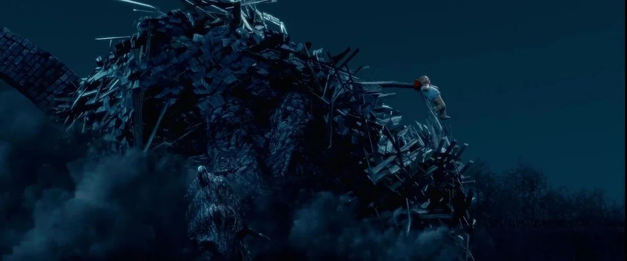 Monster House (2006) movie still: wide — A massive mountain of splintered wood and broken timber rises against a dark sky. A lone small boy clings…