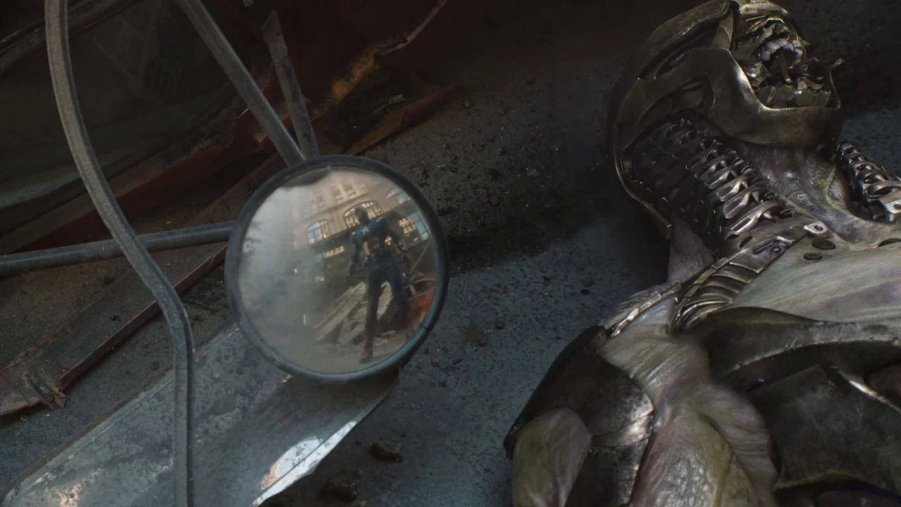 The Avengers (2012) movie still: medium — An urban setting littered with debris features a discarded metallic robotic torso. A circular side-view…