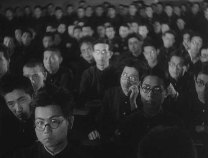 No Regrets for Our Youth (1946) movie still: medium — A crowded lecture hall filled with young men sitting in tight, dark rows. The students stare…