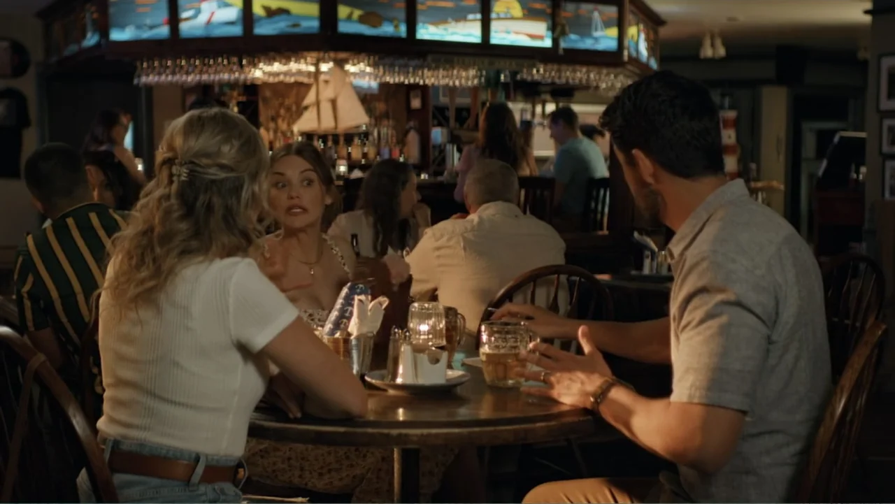 Making Waves (1998) movie still: medium — A dimly lit restaurant bar features patrons sitting at tables and a nautical decor motif. A man and woman…
