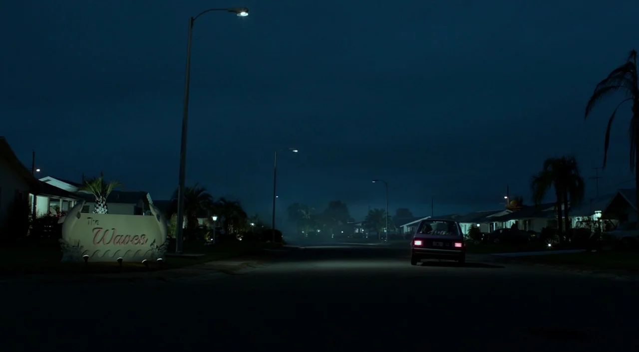 Miss Peregrine’s Home for Peculiar Children (2016) movie still: wide — A dark residential street at night with low-slung houses and palm trees. A…