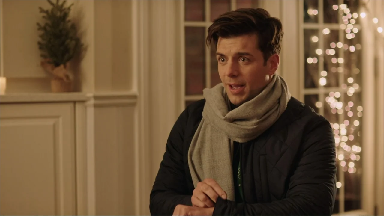 Ghosts of Christmas Past (2021) movie still: medium — A well-lit indoor space features white walls and glass paneled doors with string lights. A…