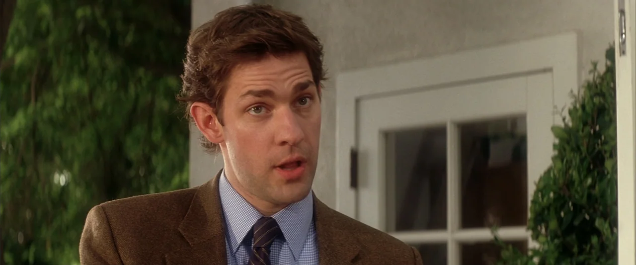 License to Wed (2007) movie still: medium — A man stands in a brightly lit exterior doorway with greenery on both sides. The man wears a…