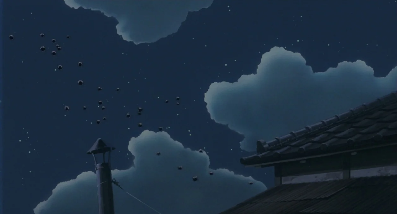 My Neighbour Totoro (1988) movie still: establishing — A night sky filled with clouds and stars hangs over the dark tiled roof. Small black soot…